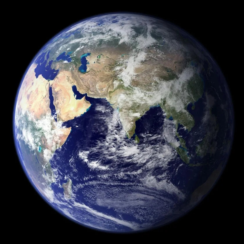 An image of Earth from space, showing Africa, Asia, and parts of Europe. The image highlights blue oceans, tan deserts, green land, and swirling white clouds.