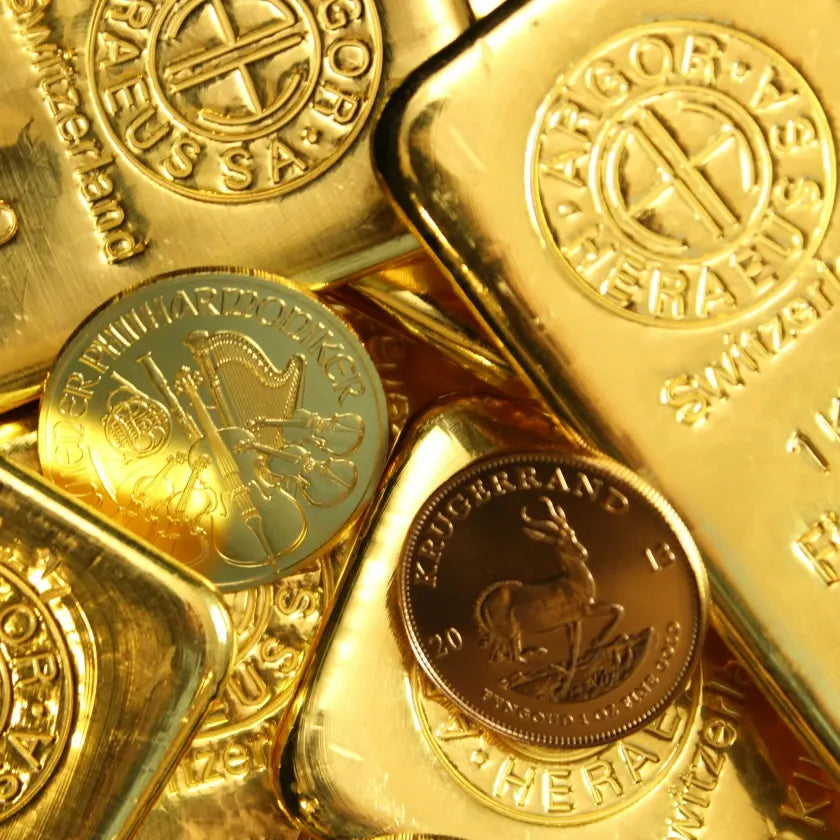 Close-up of shiny gold bars and coins with intricate engravings, including a harp and antelope. The image conveys wealth and opulence.