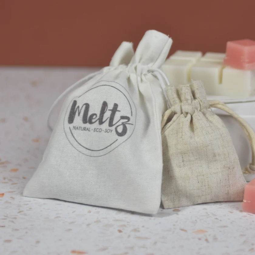 Two drawstring bags with 'Melts' branding on a textured surface.