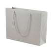 Grey eco-friendly paper gift bag with braided rope handles.