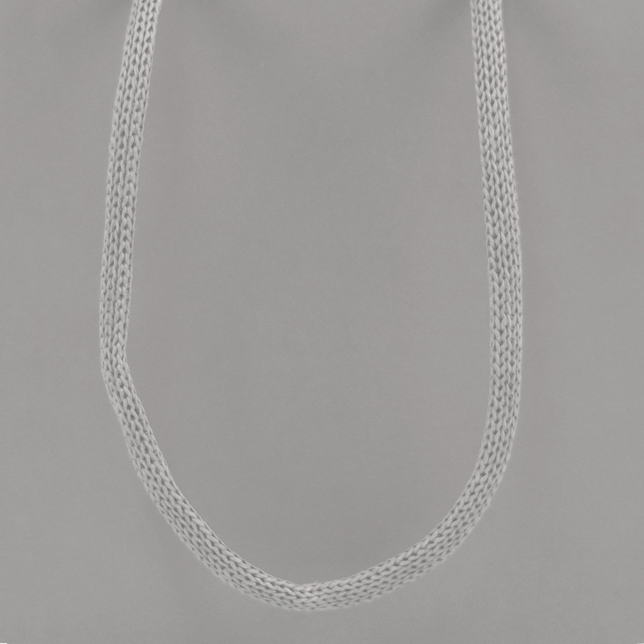 Grey eco-friendly paper gift bag with braided rope handles.