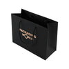 Black paper bag with 'Packaging World' text on a white background