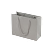 Grey eco-friendly paper gift bag with braided rope handles.