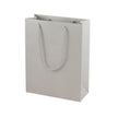 Grey eco-friendly paper gift bag with braided rope handles.