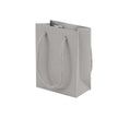 Grey eco-friendly paper gift bag with braided rope handles.