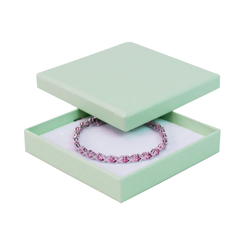 Green square recyclable eco kraft box with jewellery item.
