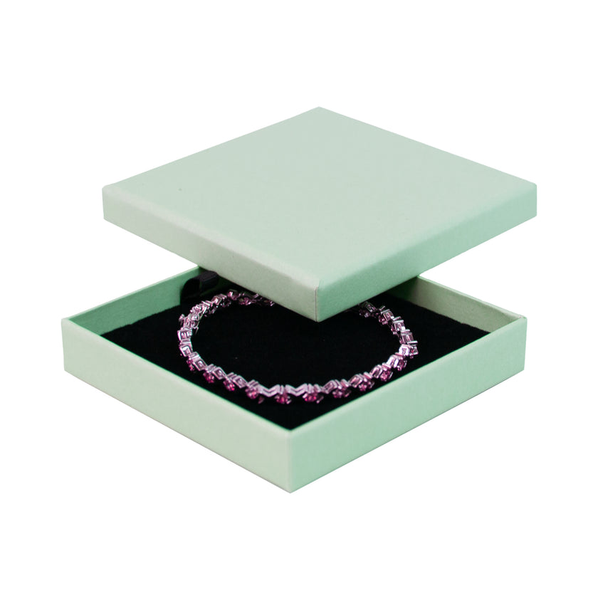 Green square recyclable eco kraft box with jewellery item.