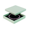 Green square recyclable eco kraft box with jewellery item.